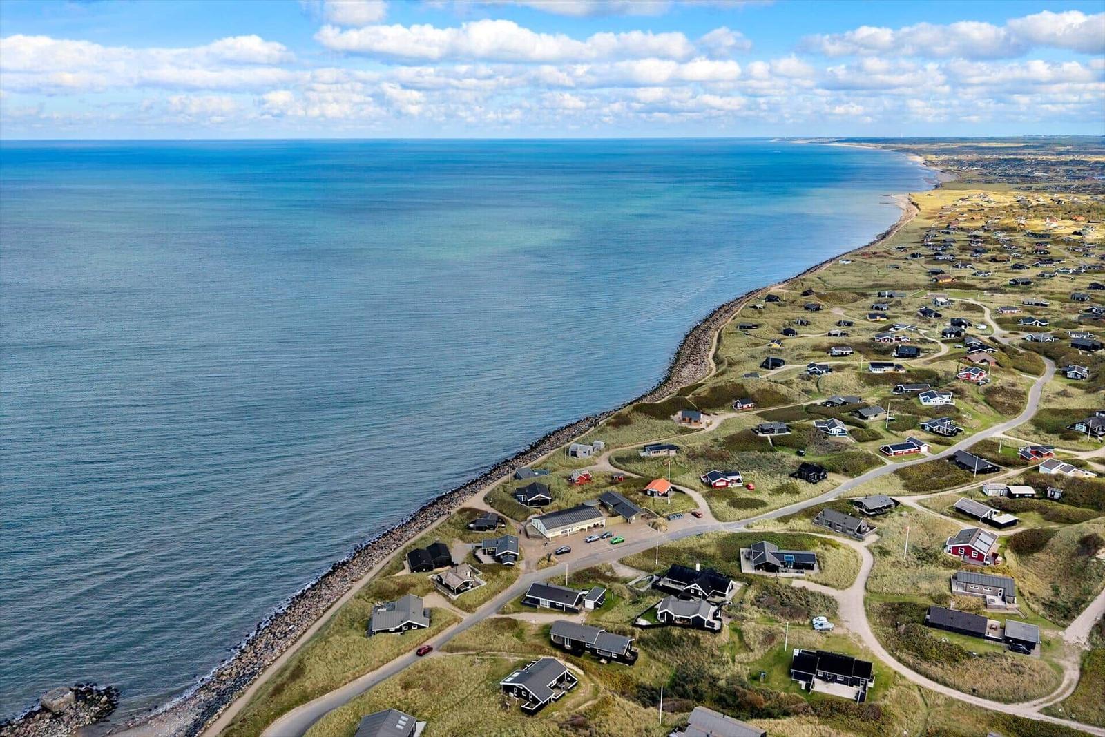 Aerial view of coastal village with houses along the sea.