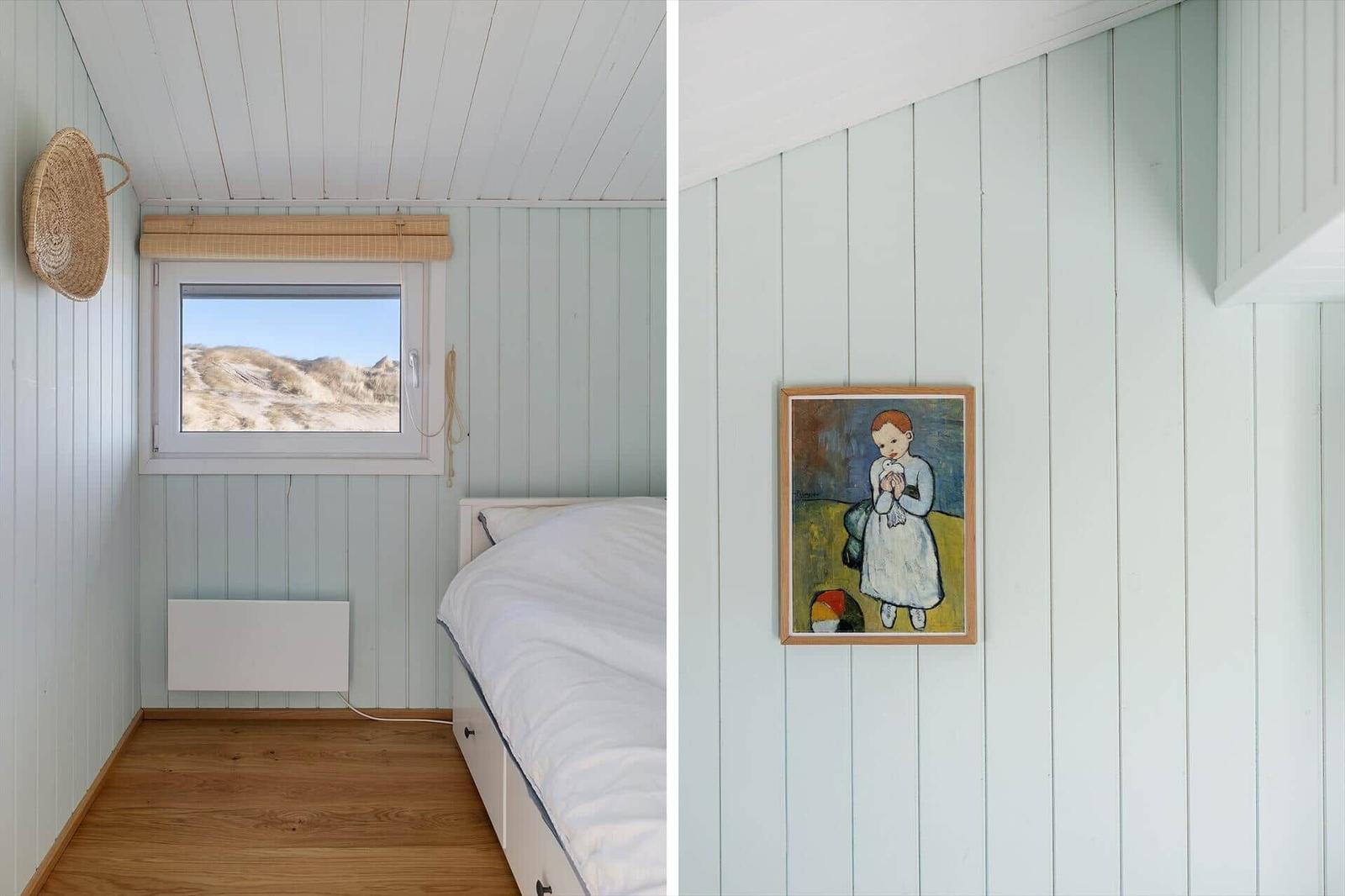 Bedroom with dune view, wall art, and wooden floor.