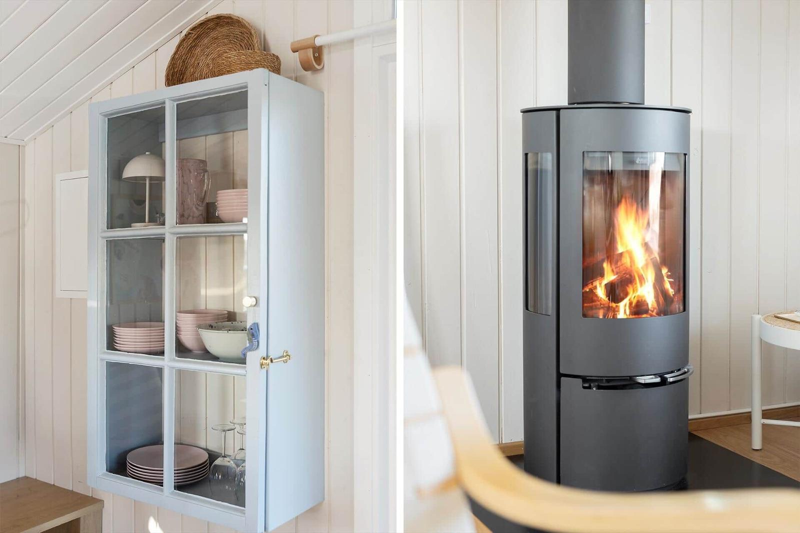 Wall-mounted cabinet with dishes and wood-burning stove