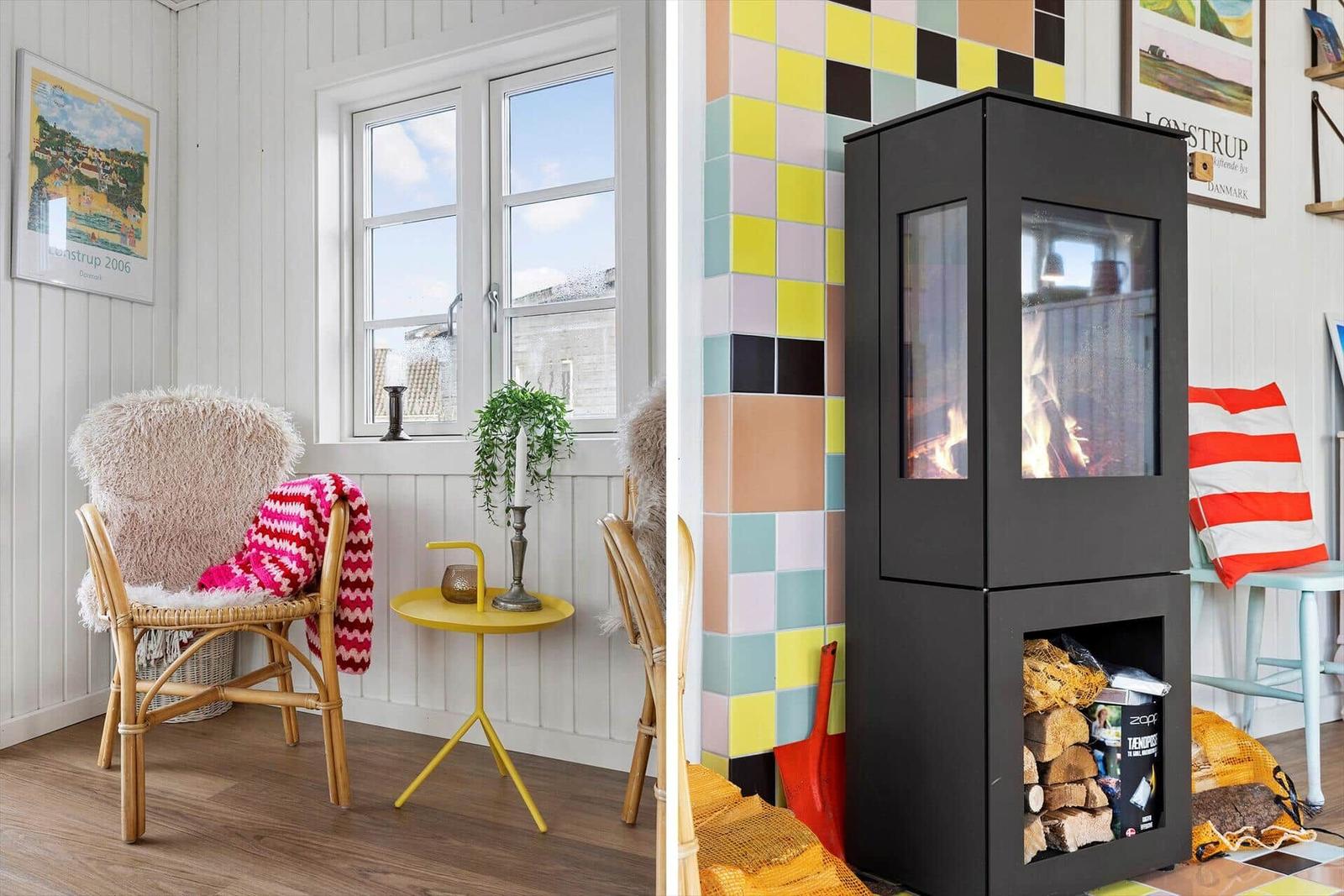 Room with seating, window, and tiled wall with wood-burning stove.
