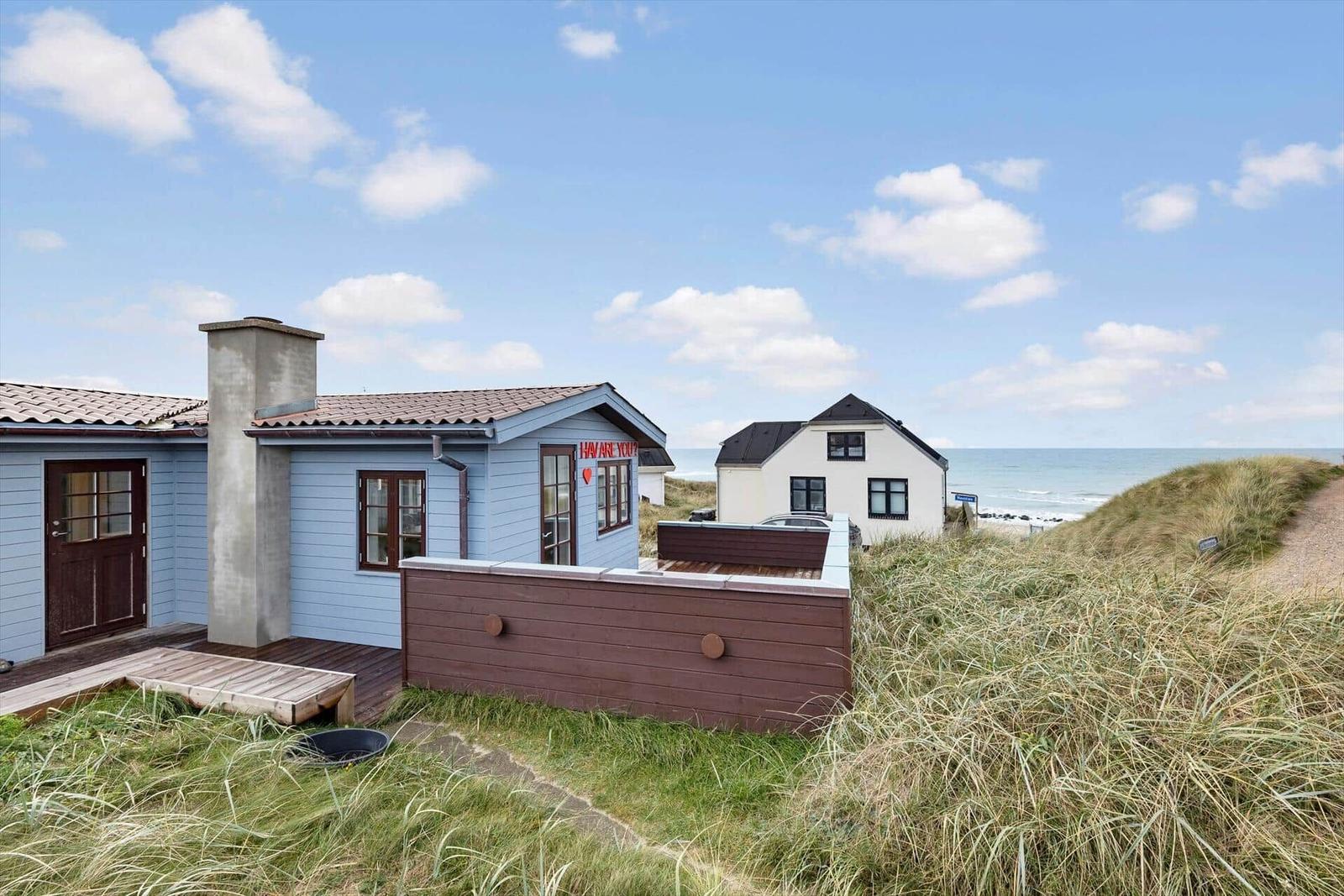 Blue house with wooden terrace and sea view