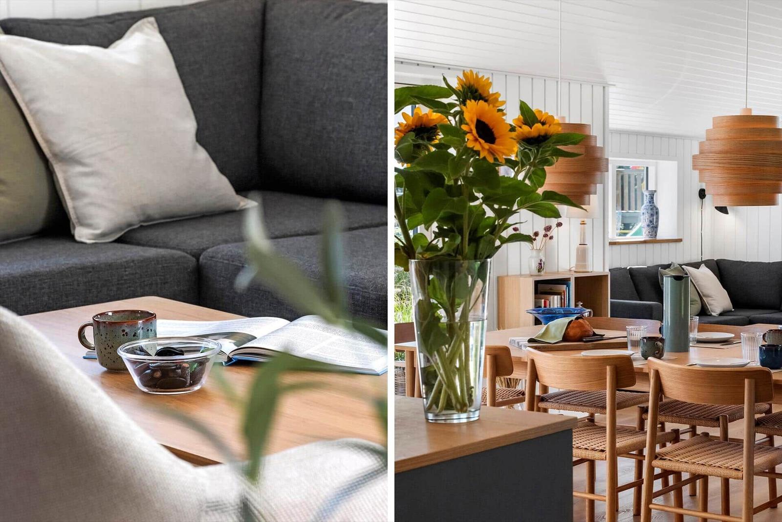 Wohnzimmer mit grauem Sofa und Holztisch. Essbereich mit Sonnenblumen und Holzstühlen.
