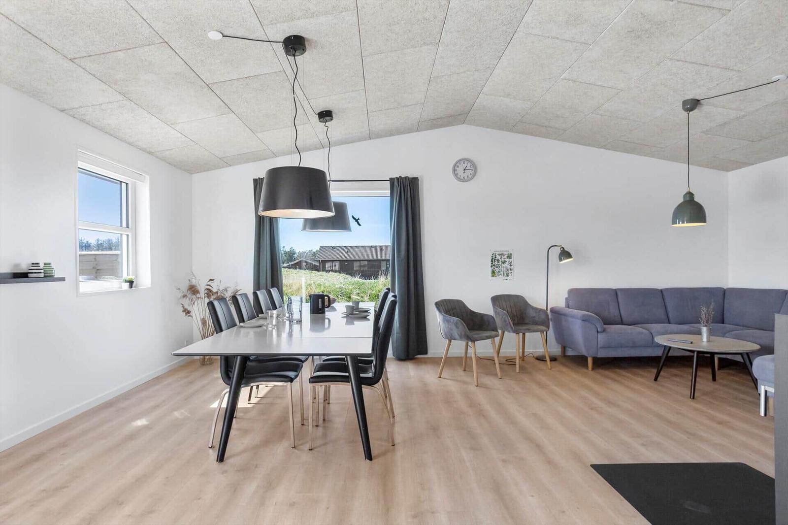 Dining room with table, chairs, and view of the landscape.