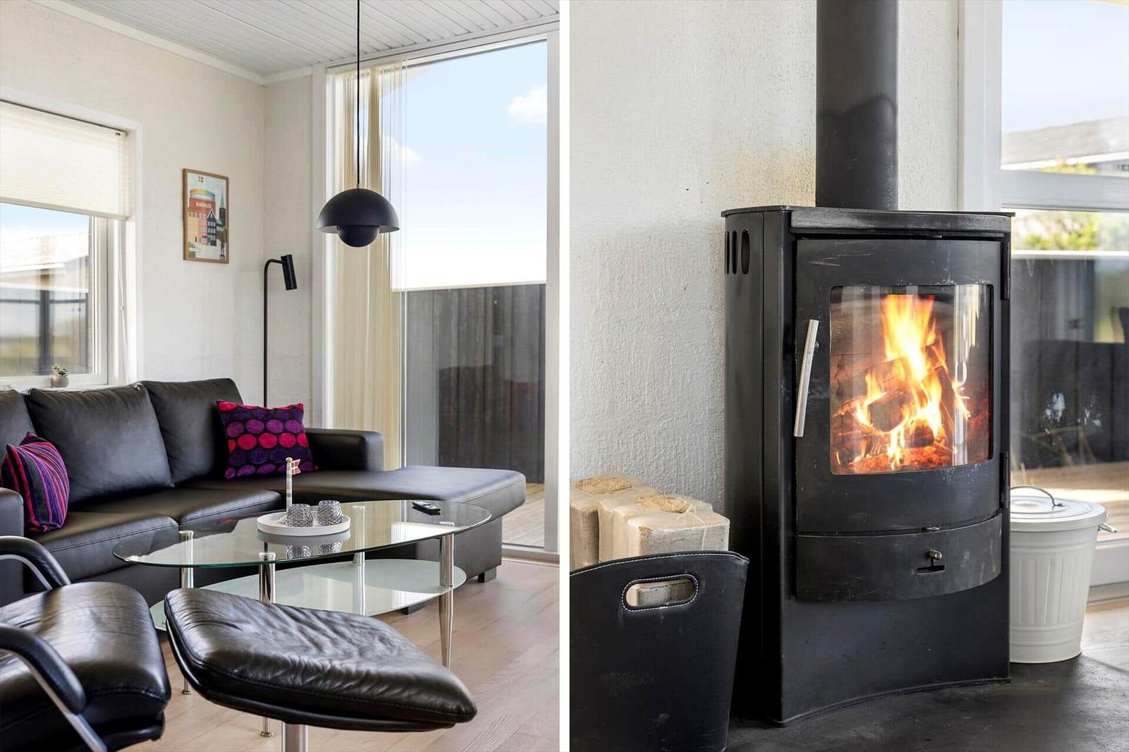 Living room with sofa, coffee table, and wood-burning stove.