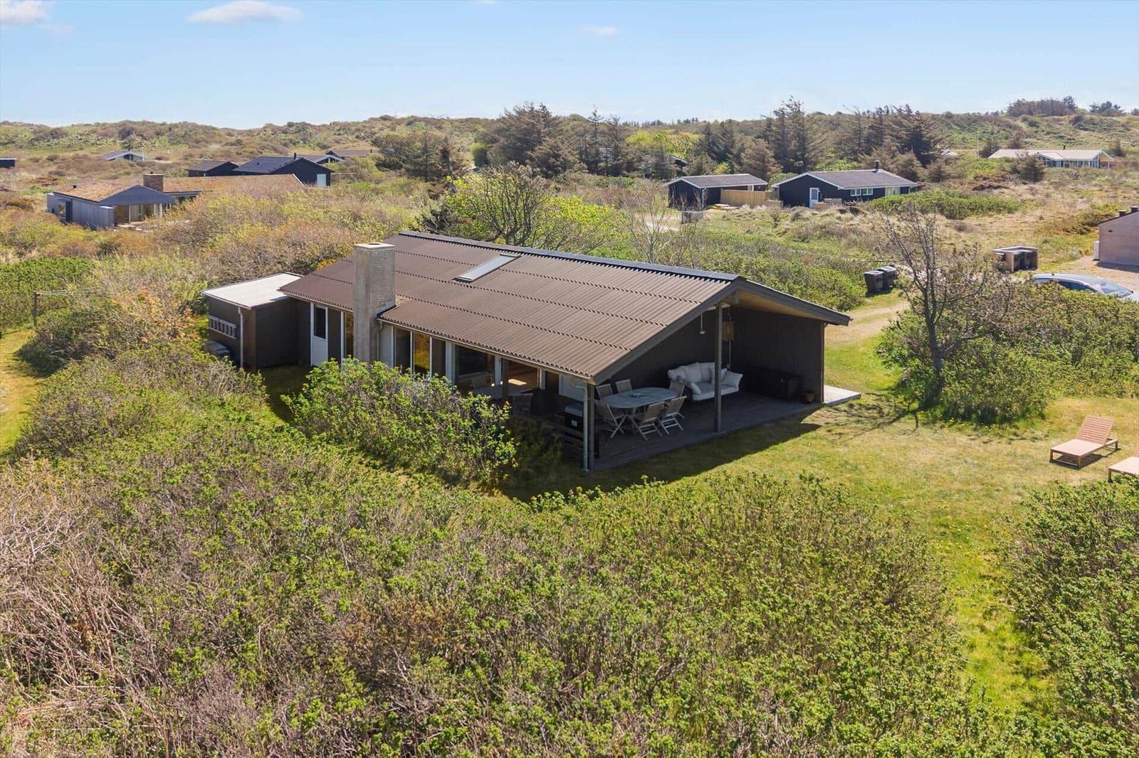 Modern vacation home with terrace and garden in rural setting.