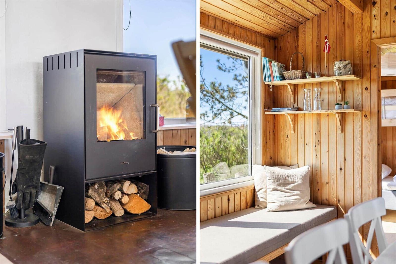 Wood stove with firewood and window seat with view.