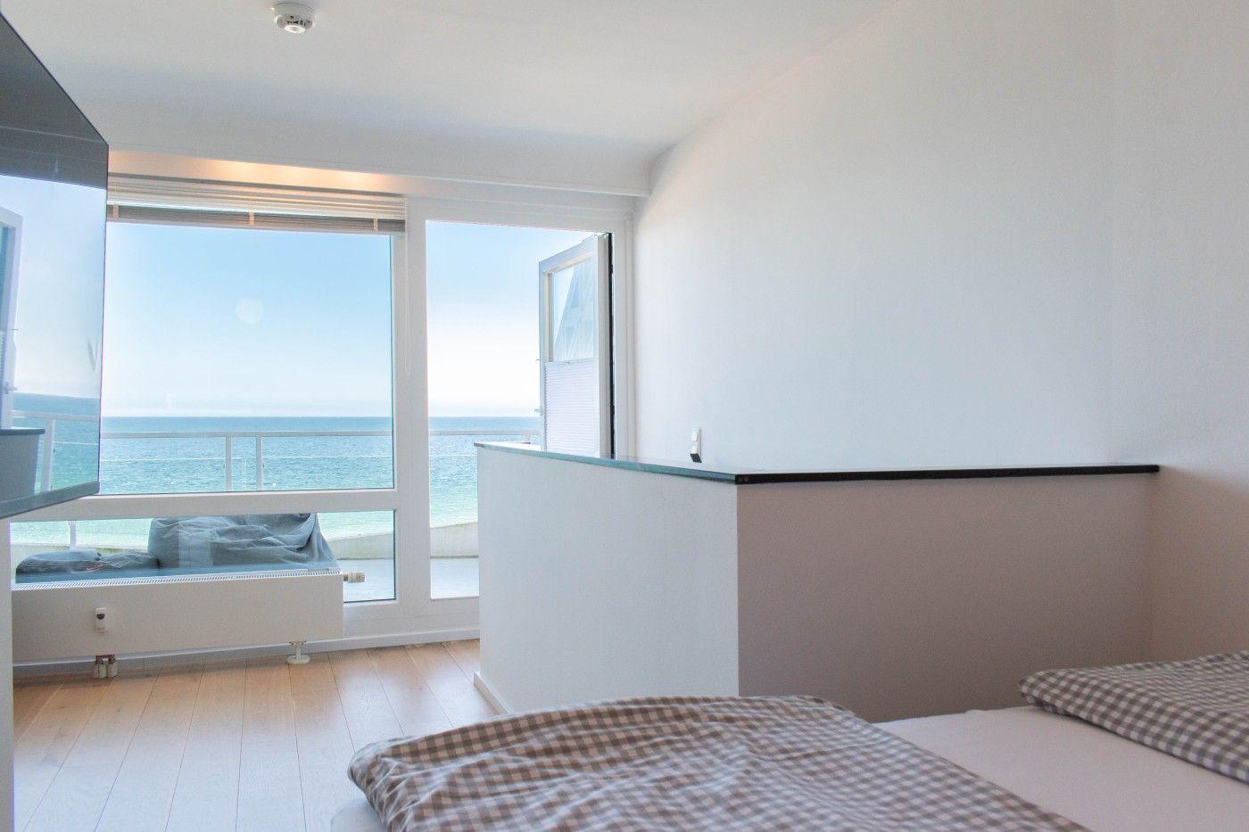 Schlafzimmer mit Blick auf das Meer und Balkon.