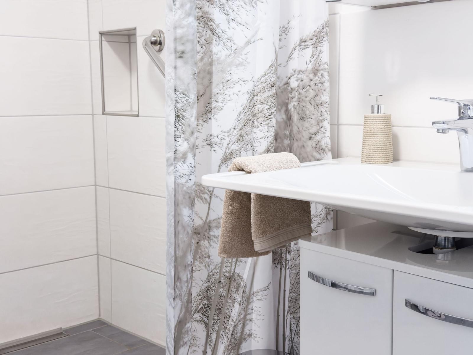 Bathroom with shower curtain, sink, and towel