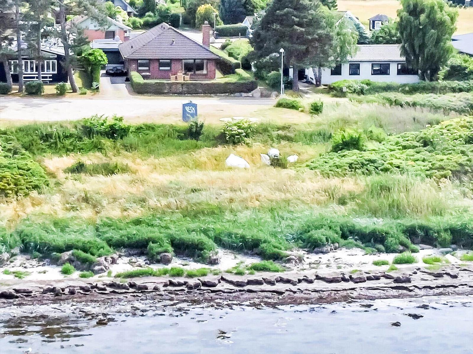 House with garden and beach in background