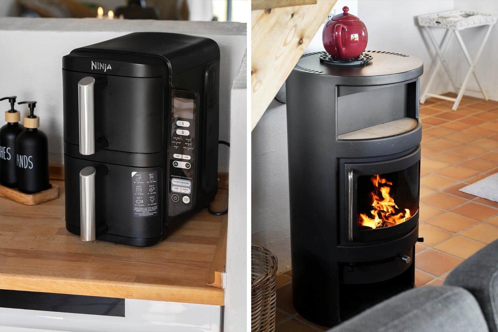 Küchenbereich mit Airfryer und Kaminofen mit brennendem Feuer.