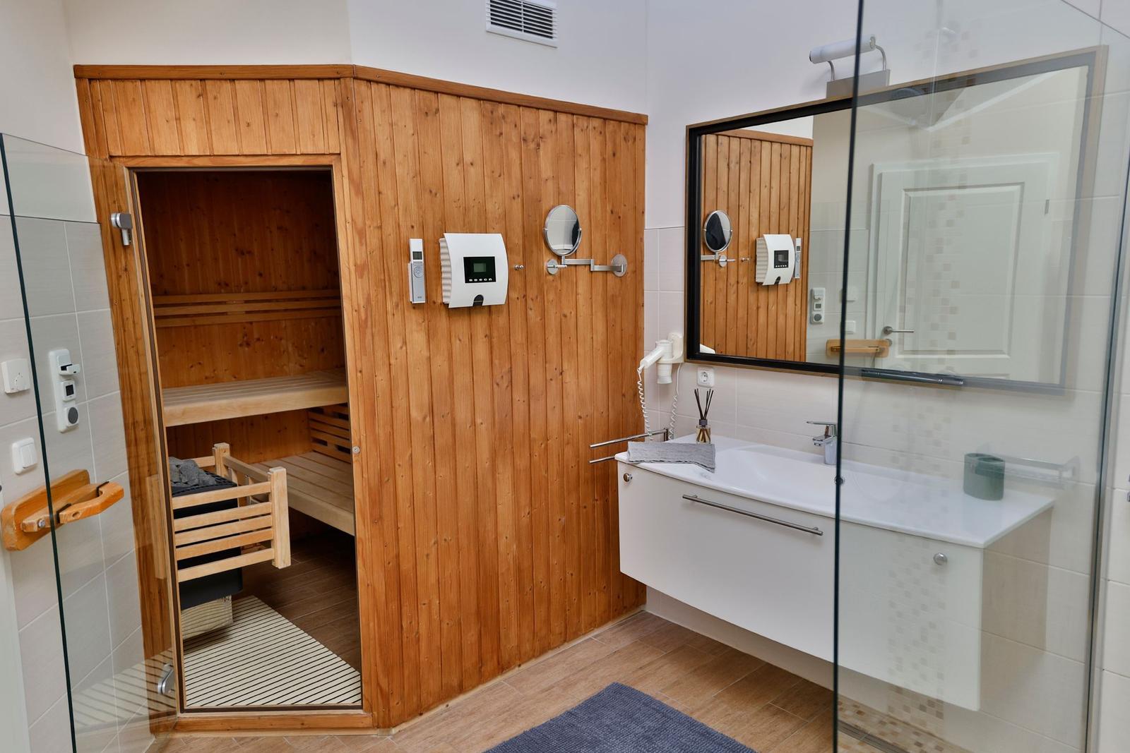 Bad mit Sauna, Waschbecken und Spiegel