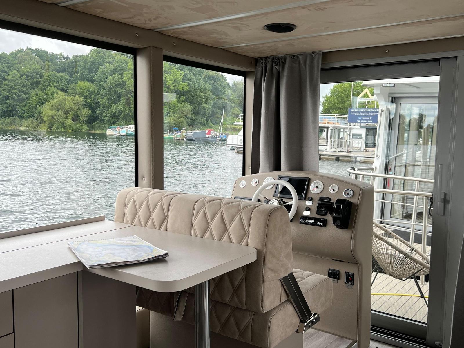 Kabinenbereich mit Steuerpult und Blick auf den See.