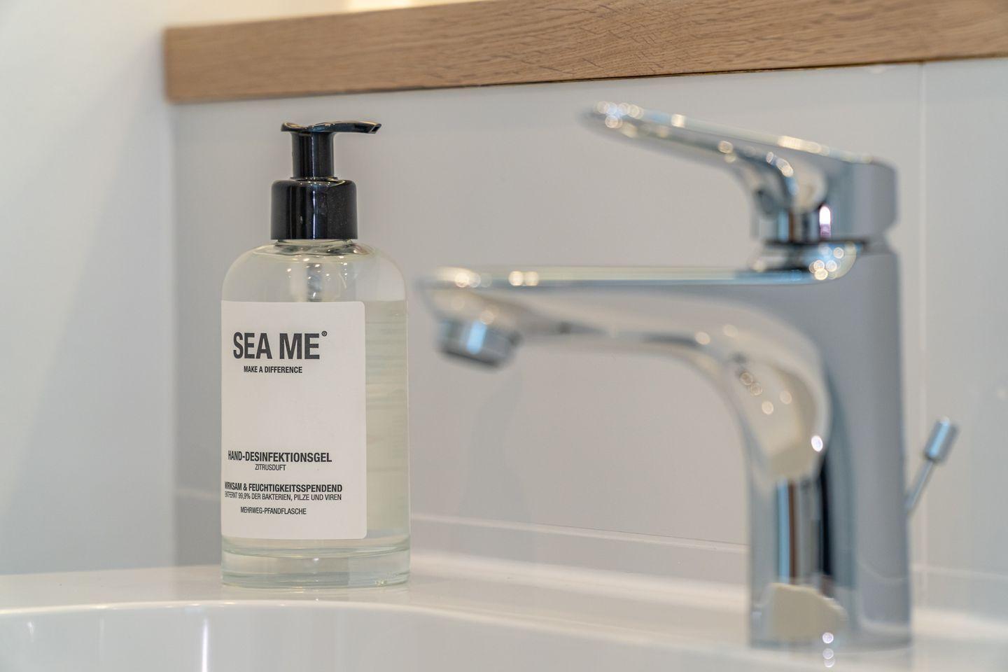 Hand disinfection gel and faucet on sink