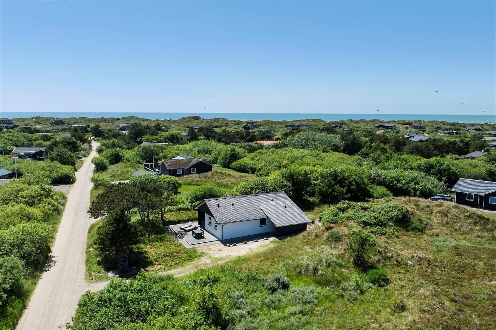 Haus mit Terrasse in grüner Umgebung, Blick auf das Meer.