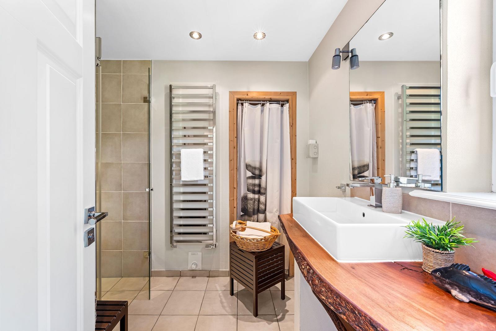 Bathroom with shower, sink, and heater