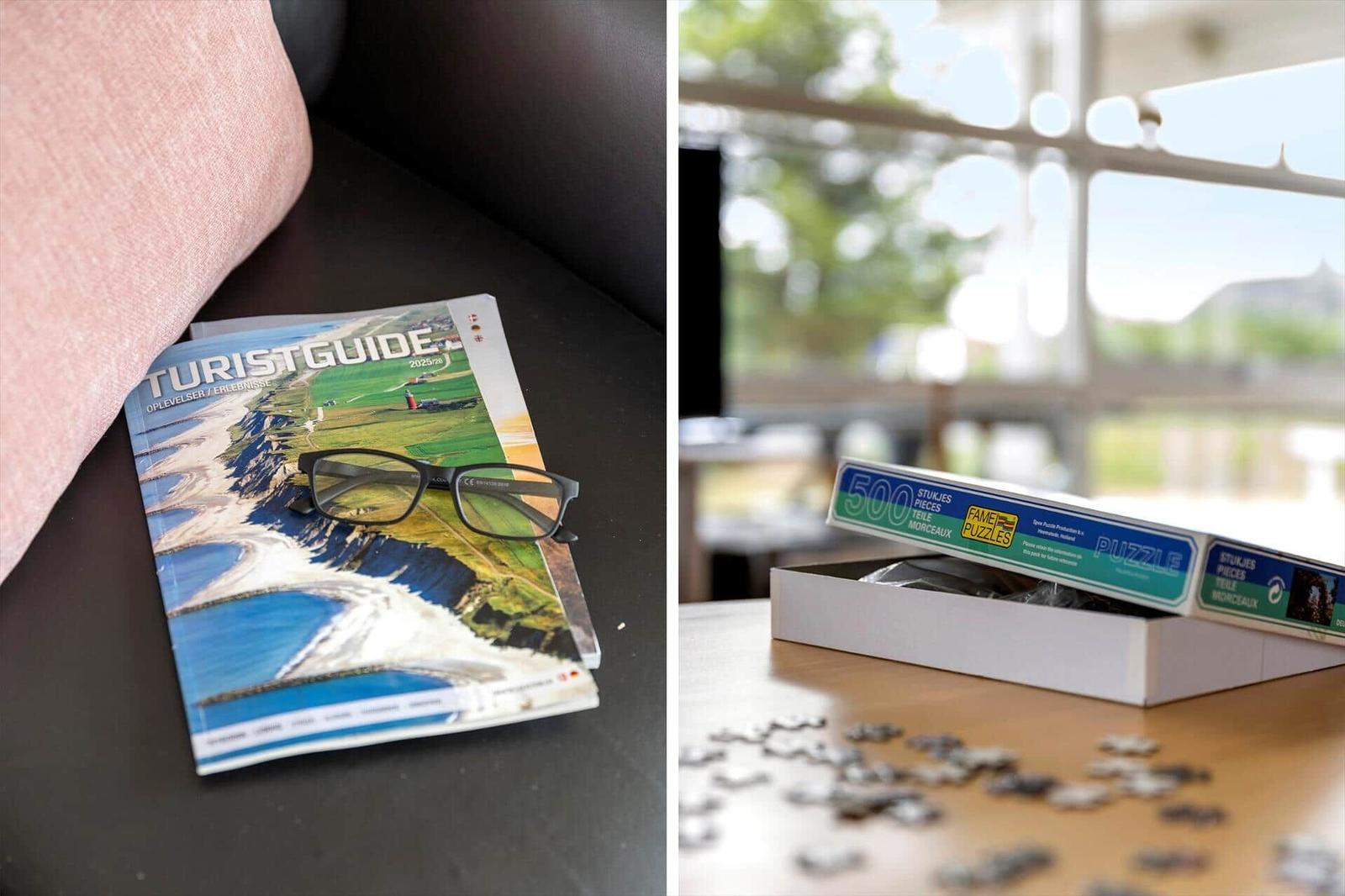 Tourist Guide und Puzzle auf Tisch. Fensterblick auf Außenbereich.