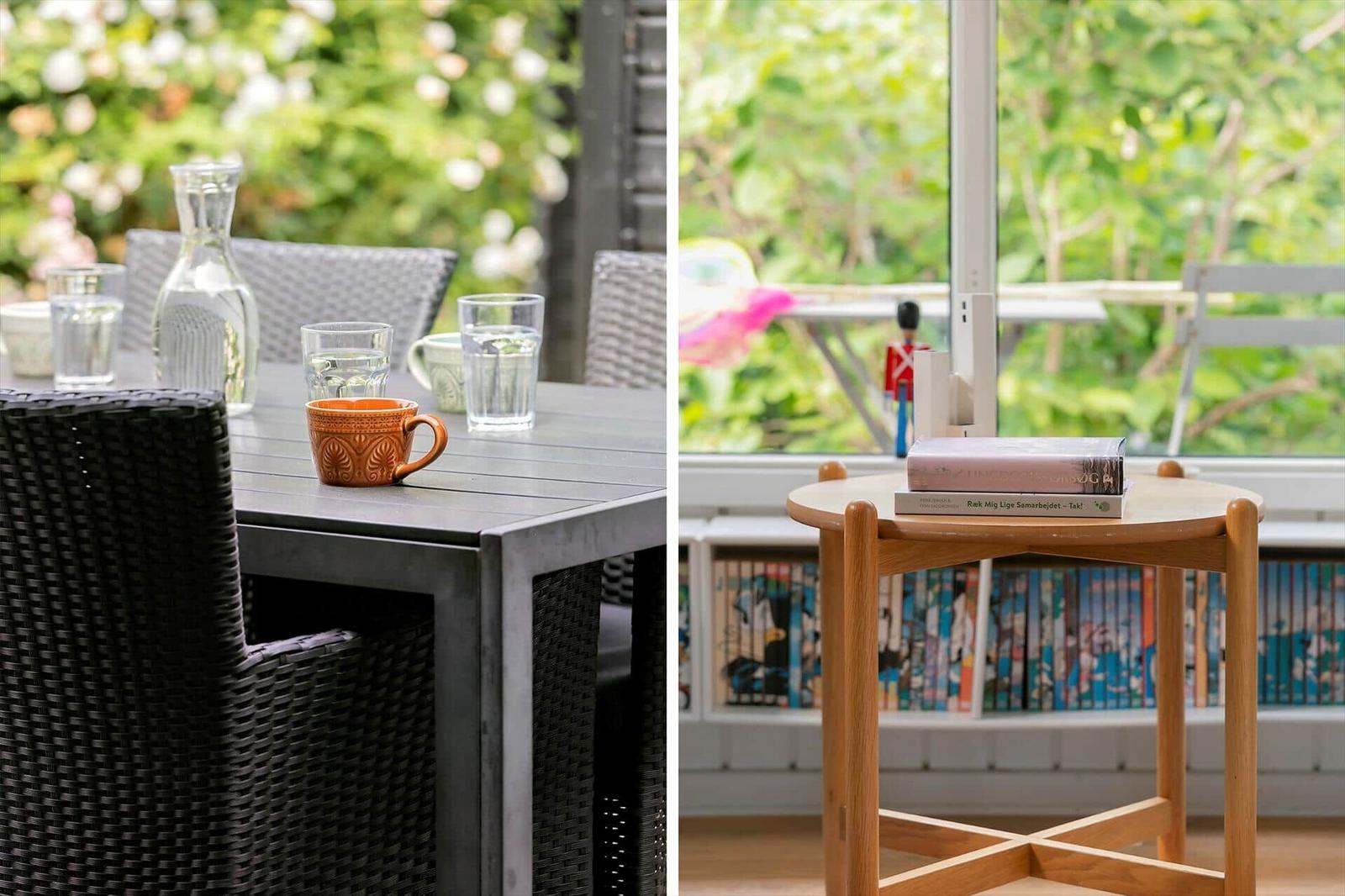 Outdoor area with table and chairs. Inside: wooden table with books and garden view.