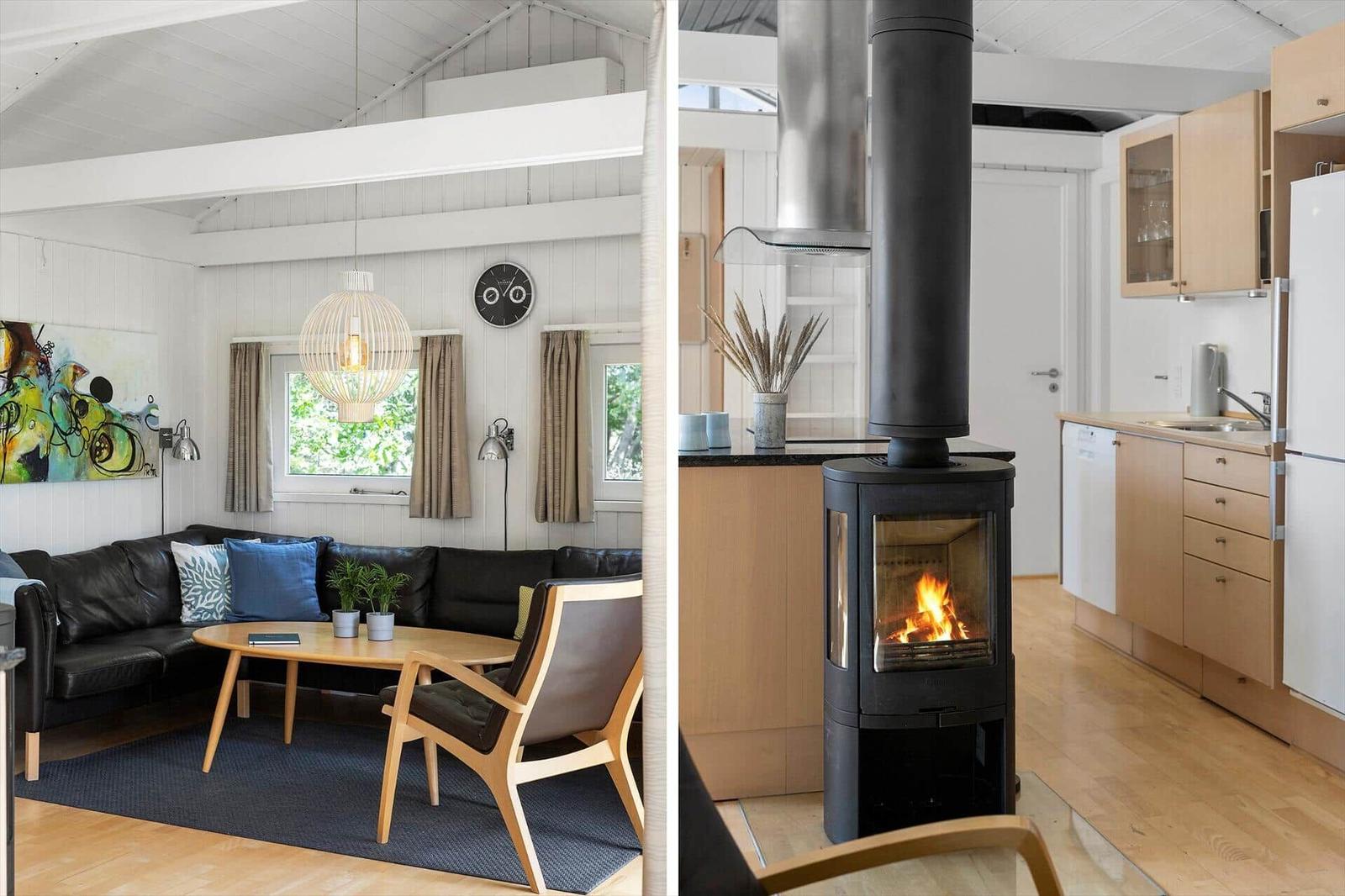 Wohnzimmer mit Sofa und Esstisch. Küche mit Holzmöbeln und Kaminofen.