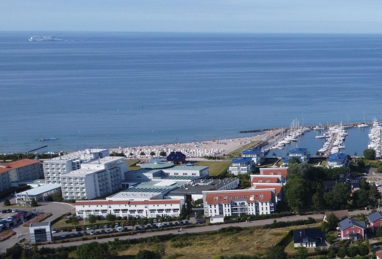 Harbor with boats, beach, and hotels by the coast