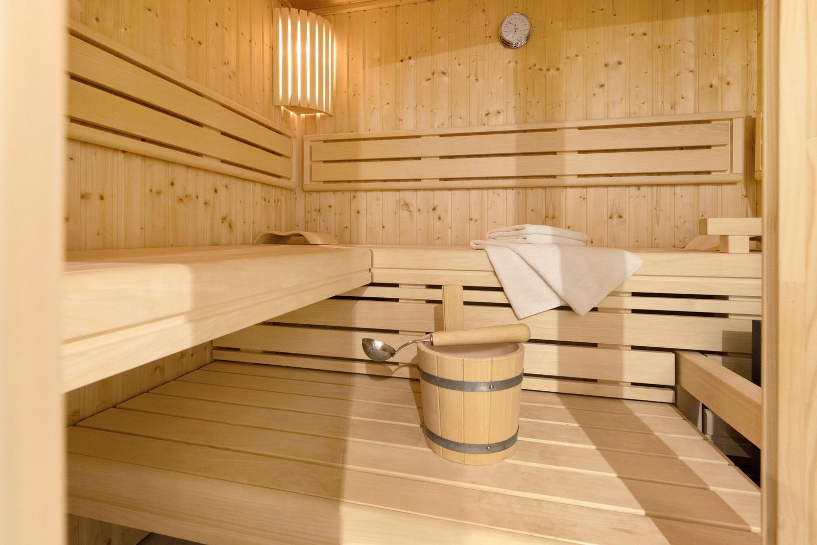 Sauna mit Holzbank, Eimer und Handtuch