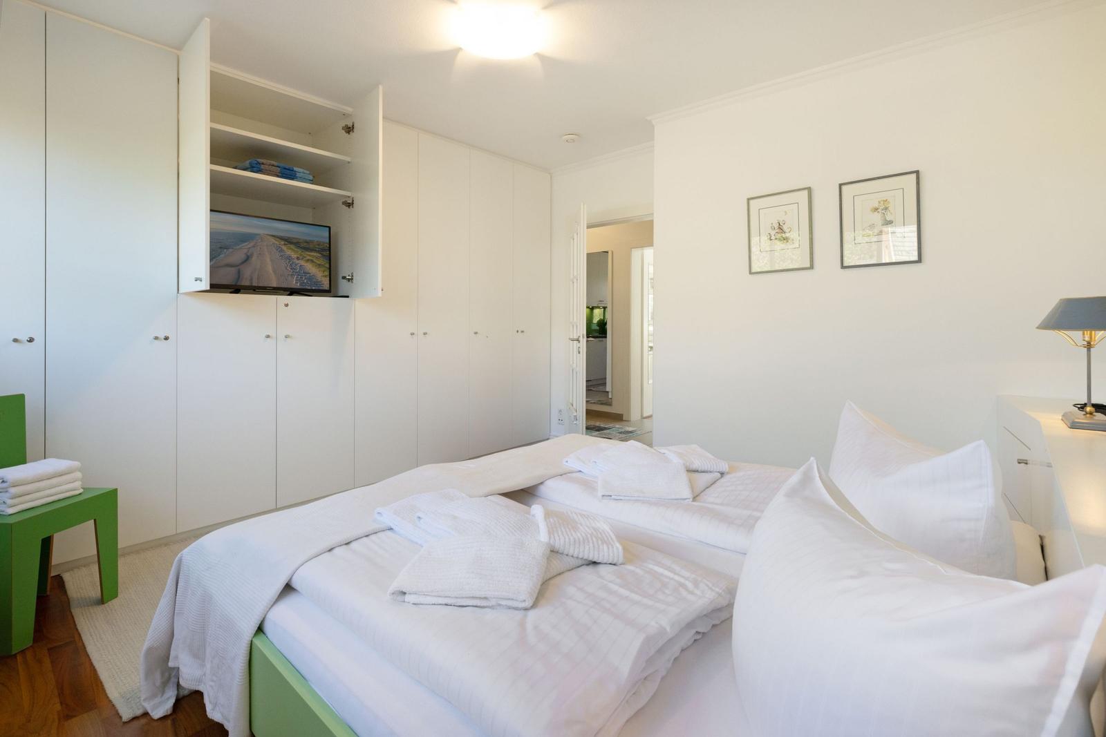 Bedroom with bed, wardrobe, and TV