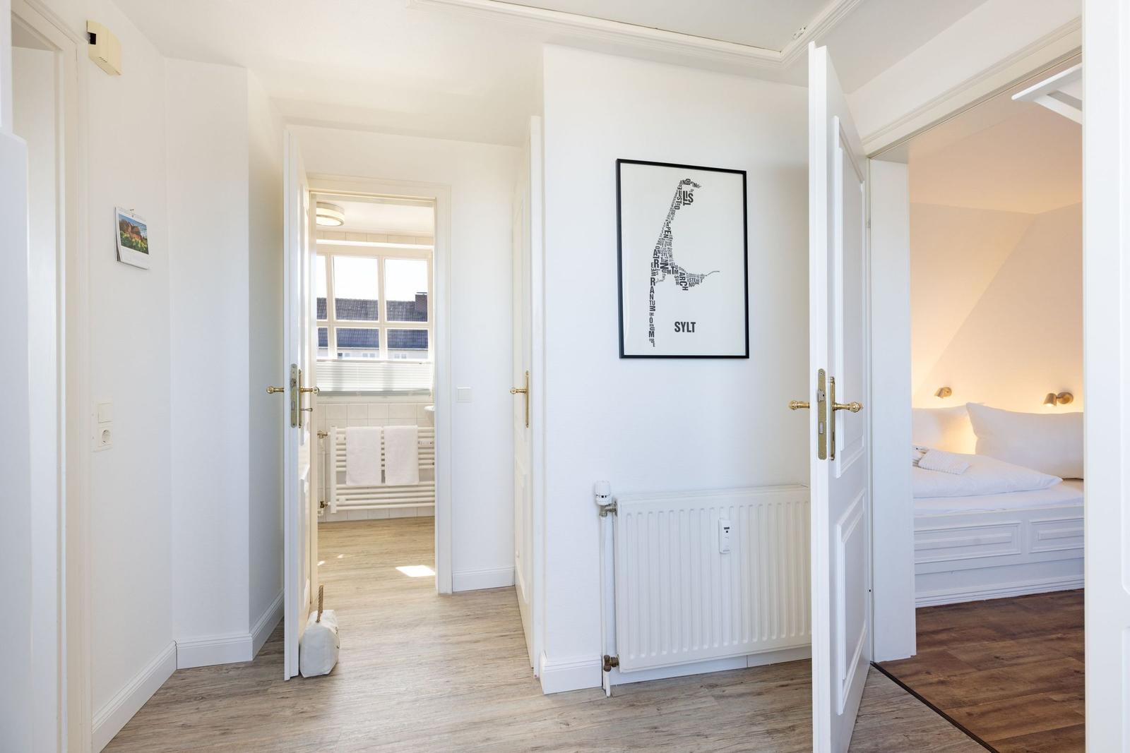Flur mit Blick in Schlafzimmer und Bad. Wandbild mit Karte von Sylt.