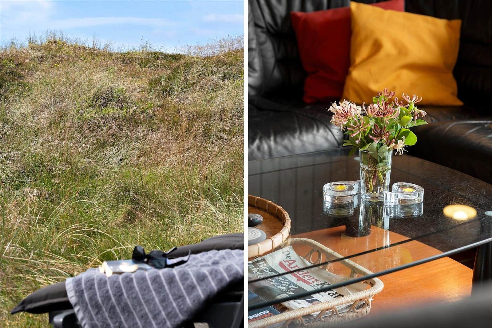 Grasbewachsener Hang mit Blick auf die Ferienwohnung. Wohnzimmer mit Sofa, Tisch und Blumen.