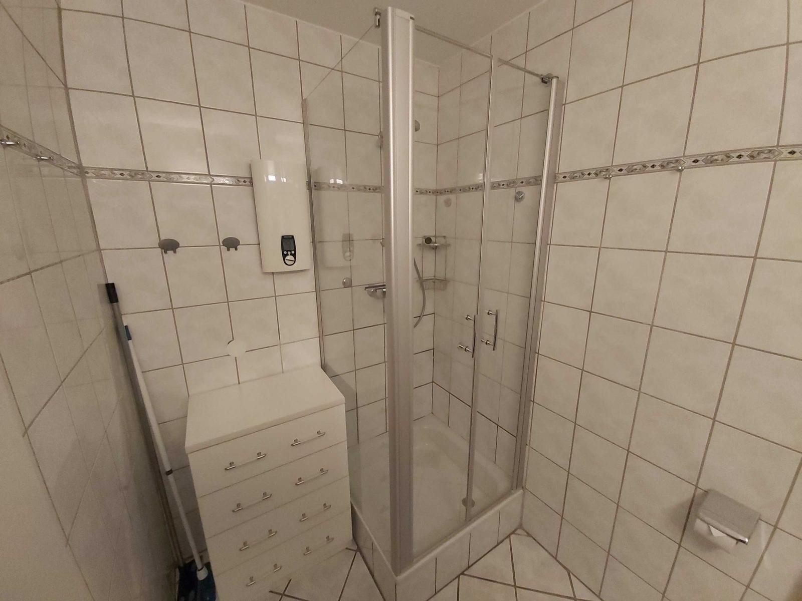 Bathroom with shower and sink.