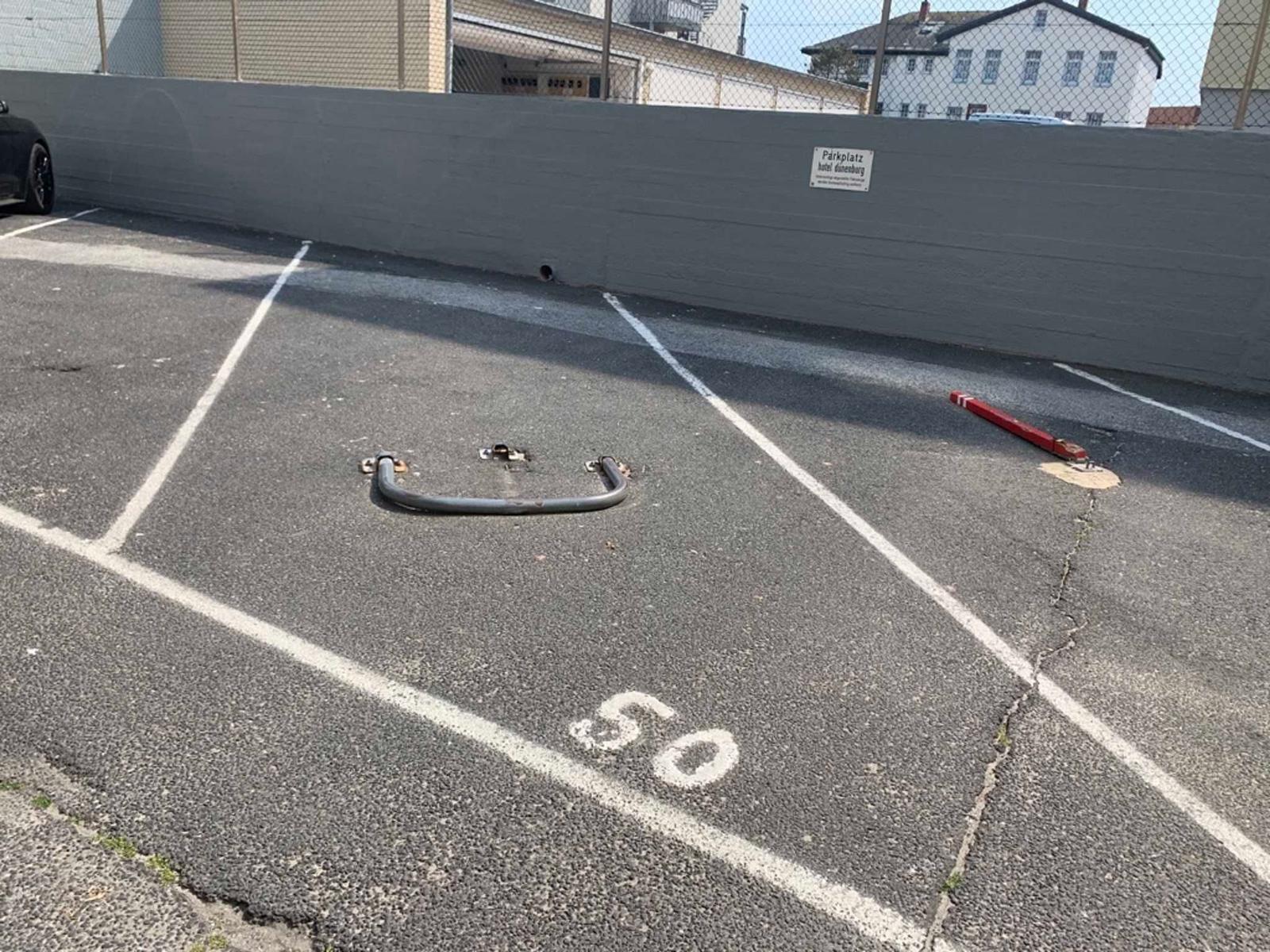 Parking lot with marked spaces and metal object