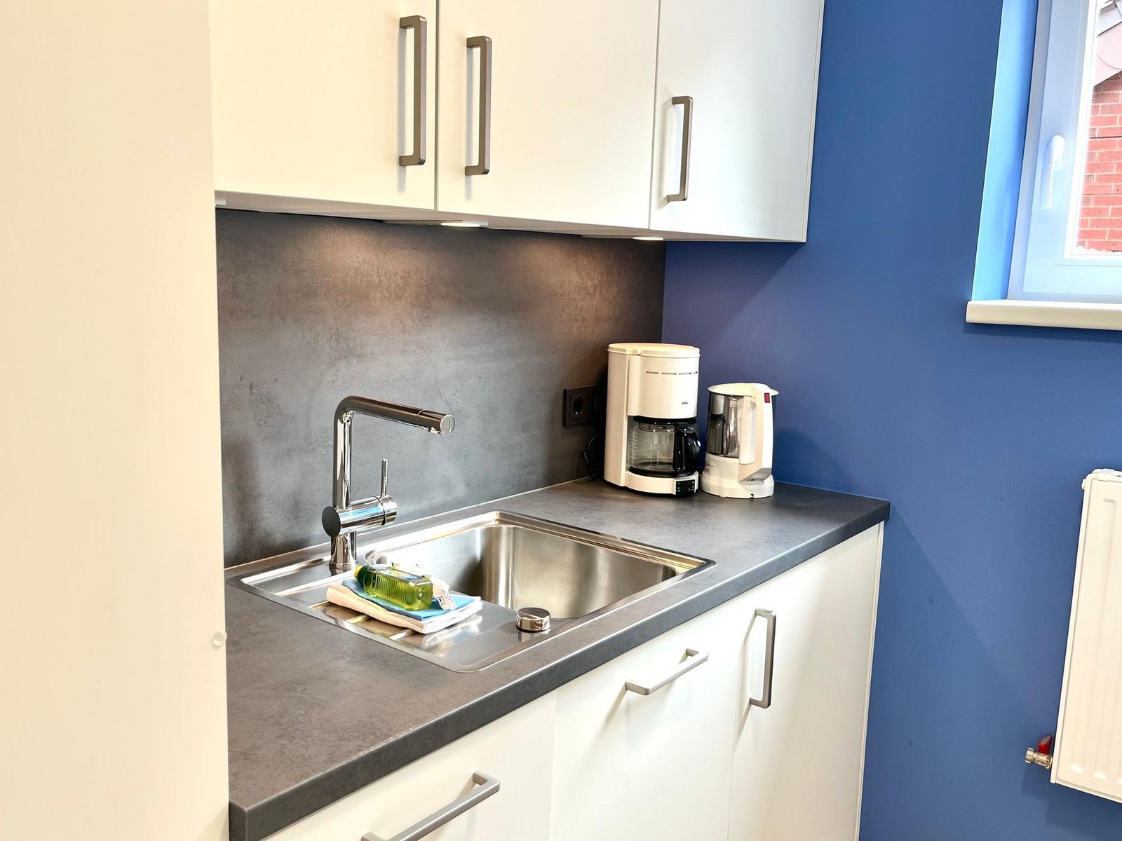 Moderne Küche mit Spülbecken und Kaffeemaschine