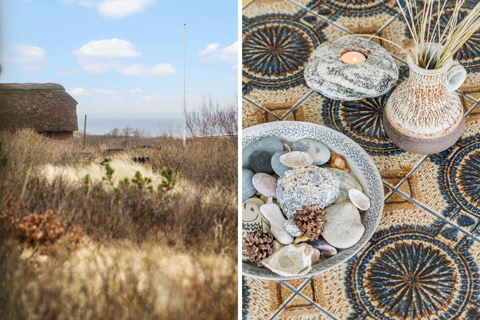 Dorfhaus mit Blick aufs Meer und dekorative Steine auf Mosaikfliesen