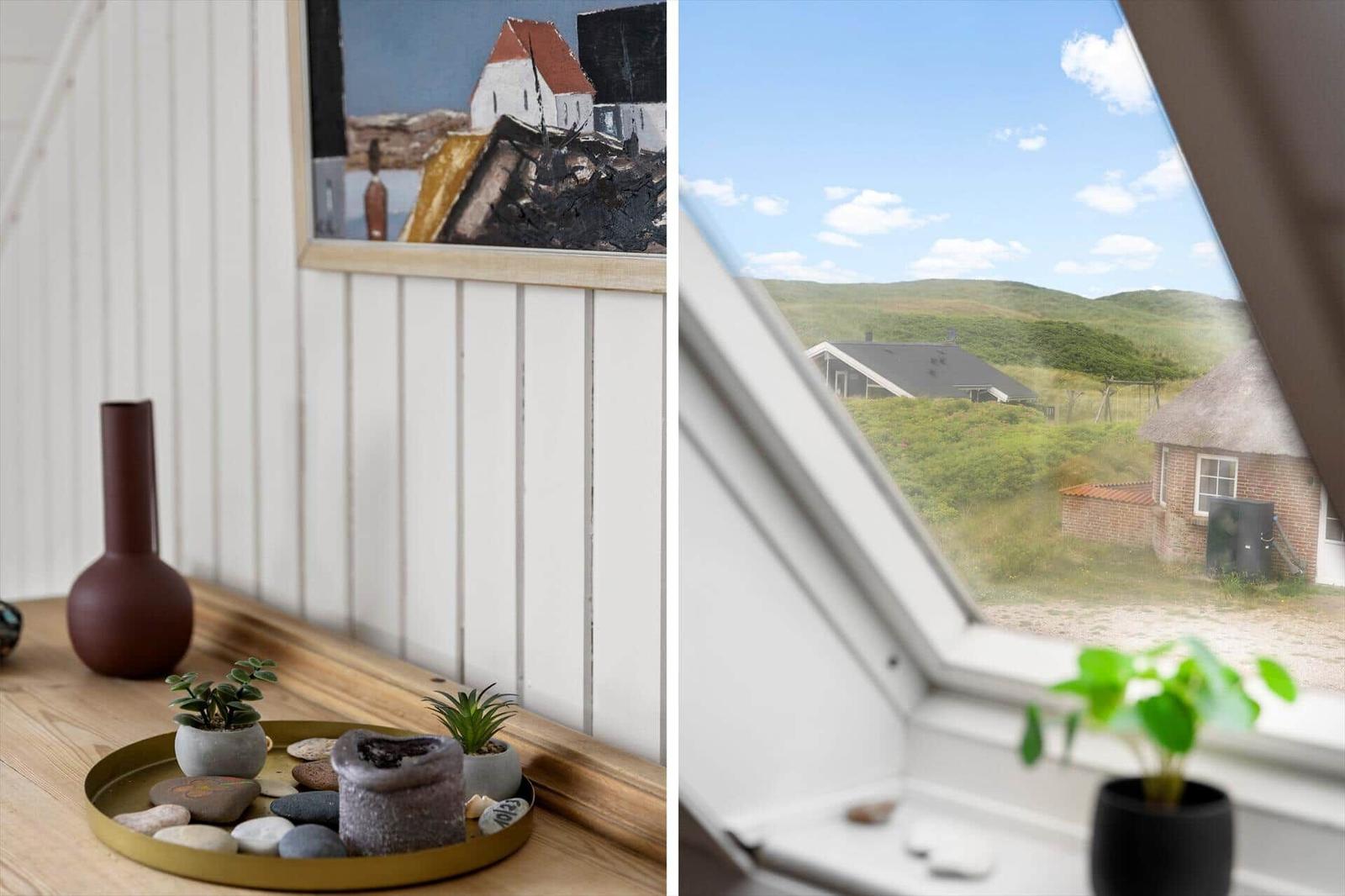 Interior with wooden shelf, picture, and plants. View of green hills and buildings.
