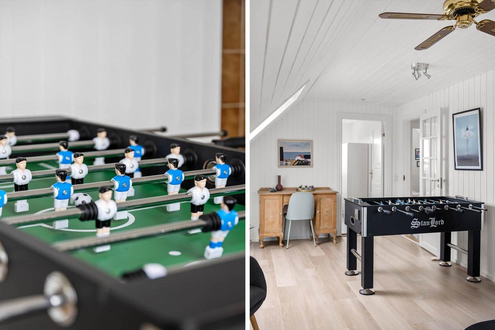 Foosball table in a room with light wood flooring and white walls.