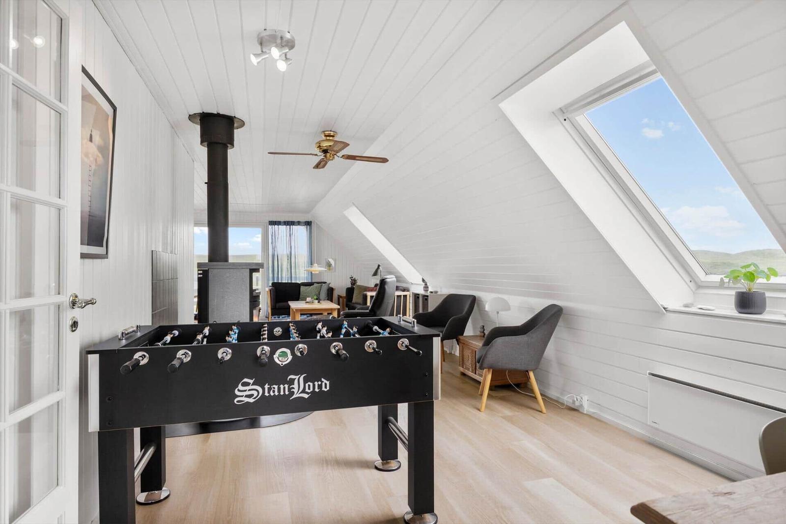 Bedroom with underfloor heating and skylight. Foosball table in foreground.