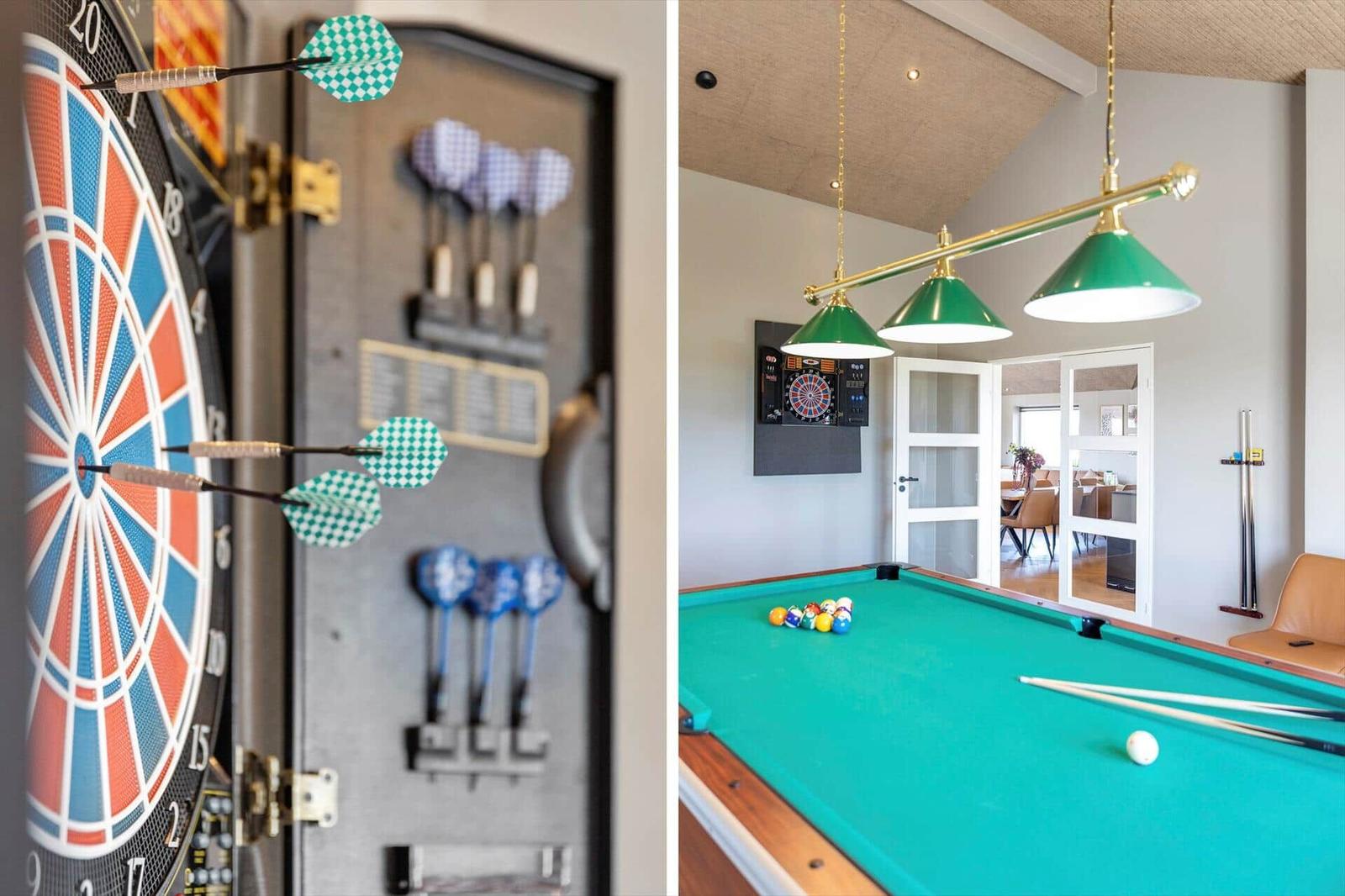 Billardtisch mit grüner Tischplatte und Dartscheibe an der Wand
