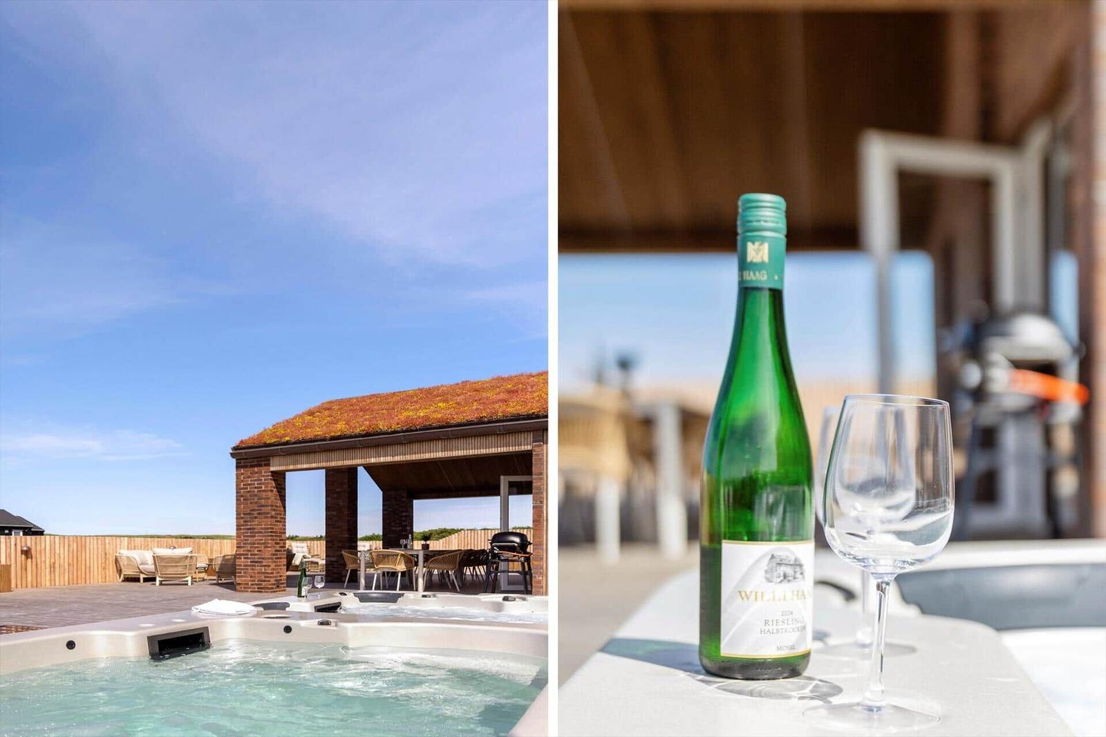Hot tub mit Terrasse und Grillbereich. Weinglas und Flasche auf Tisch.