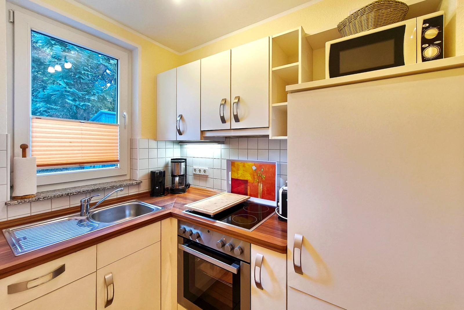 Praktische Einbauküche mit Fenster und moderner Ausstattung für Selbstversorger