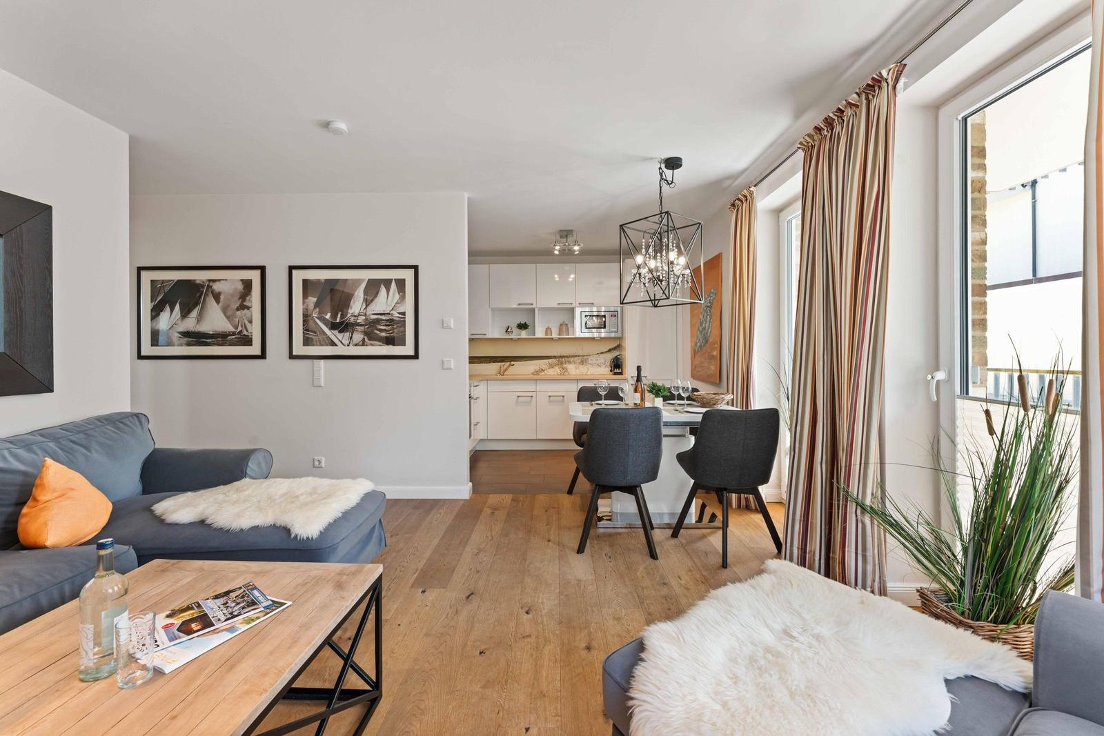 Living area with sofa, coffee table, and view into the kitchen.