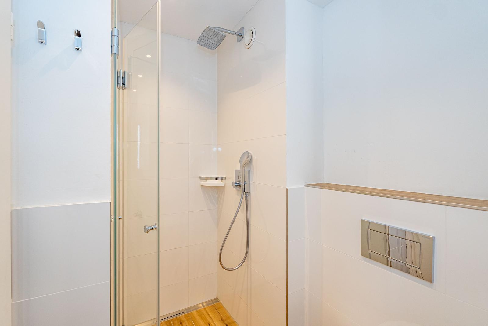 Dusche mit Glaswand, Duschbrause und Handbrause