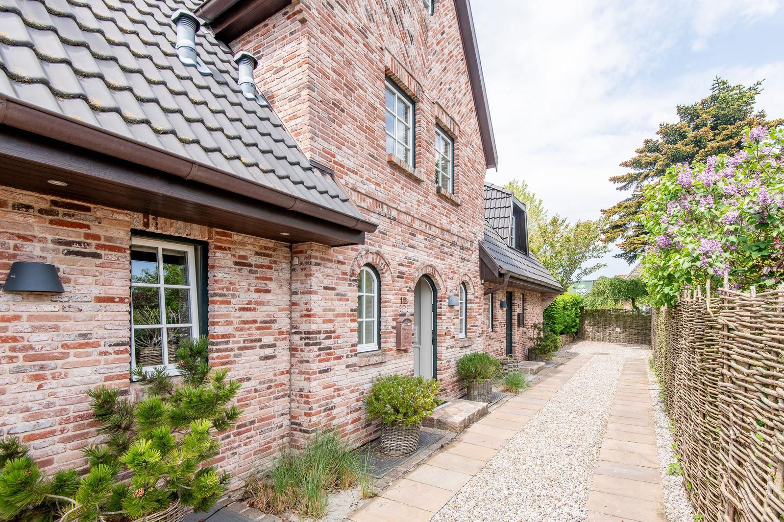 Brick house with garden gate and paved path