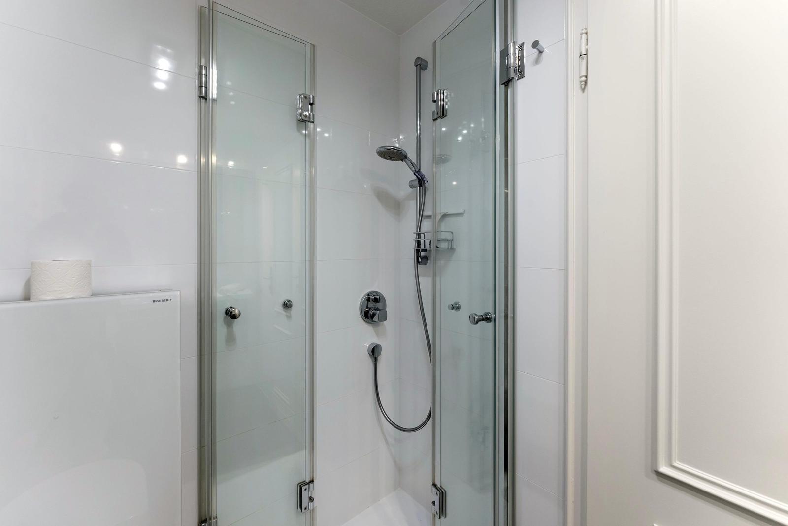 Shower with glass enclosure and showerhead
