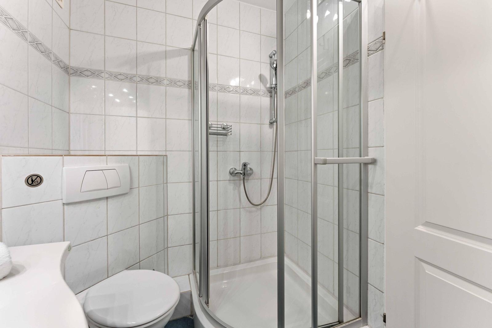 Bathroom with shower, toilet, and sink.