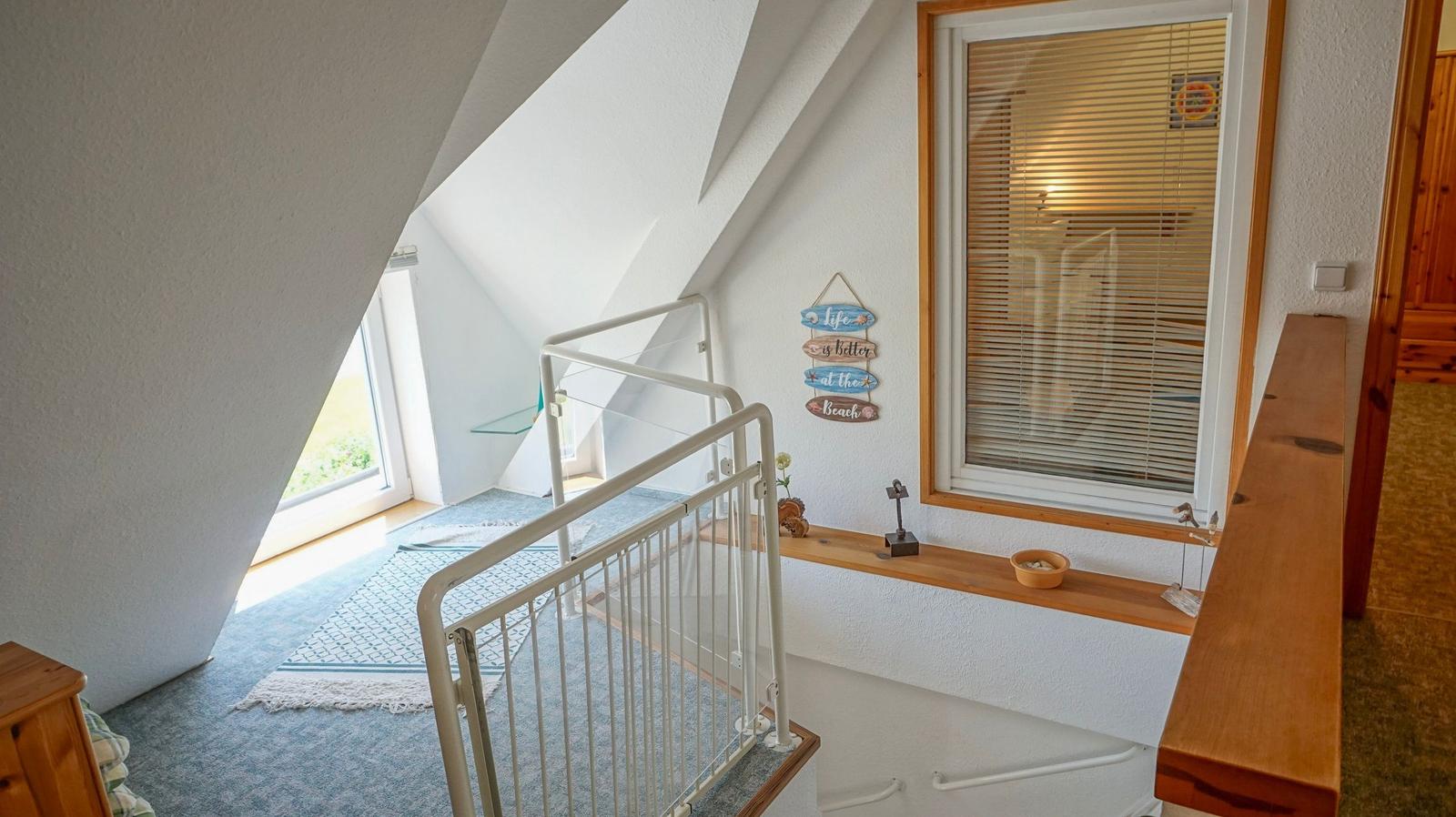 Staircase with window and sign on the wall