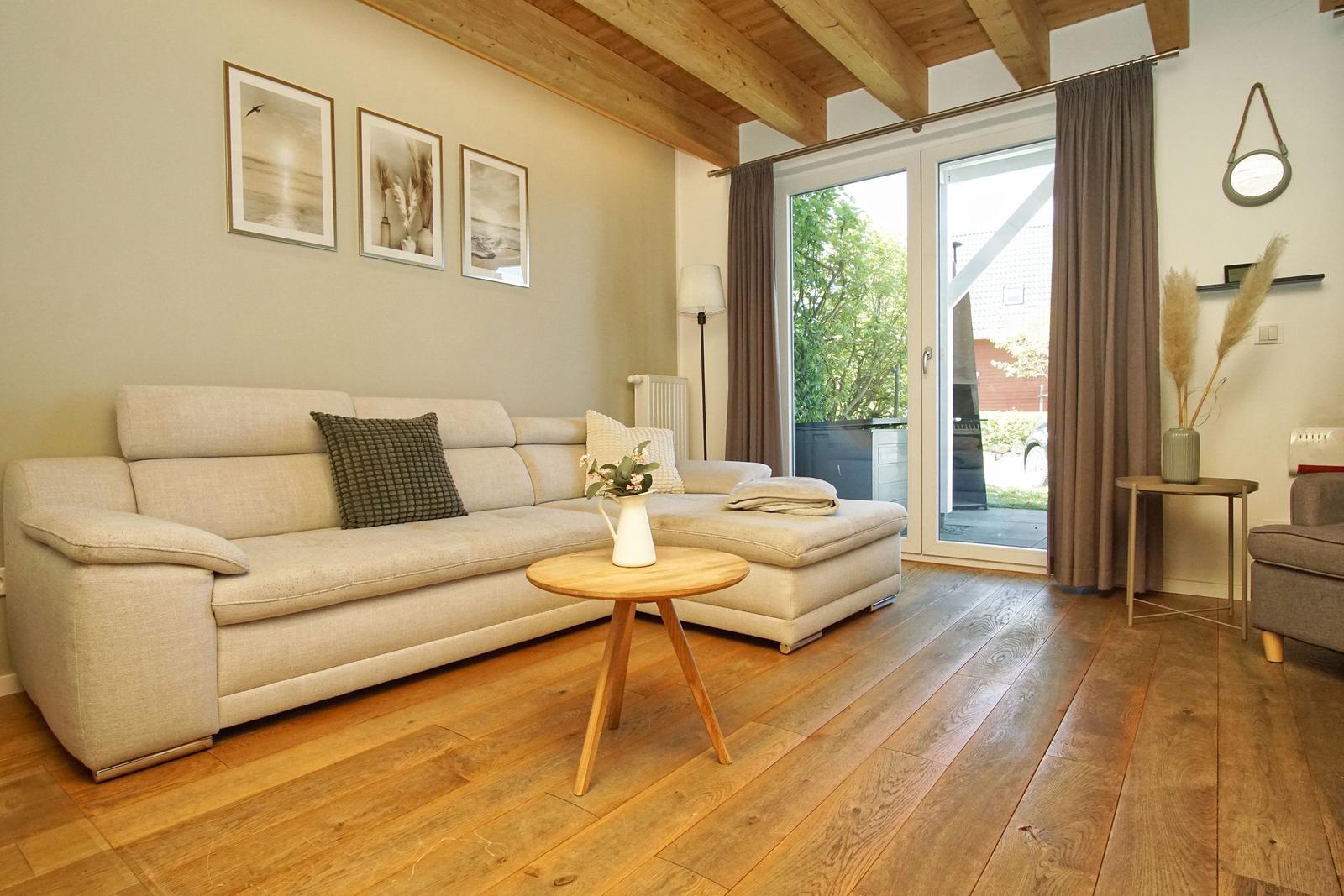 Living room with sofa, hardwood floor, and glass door to outdoor terrace.