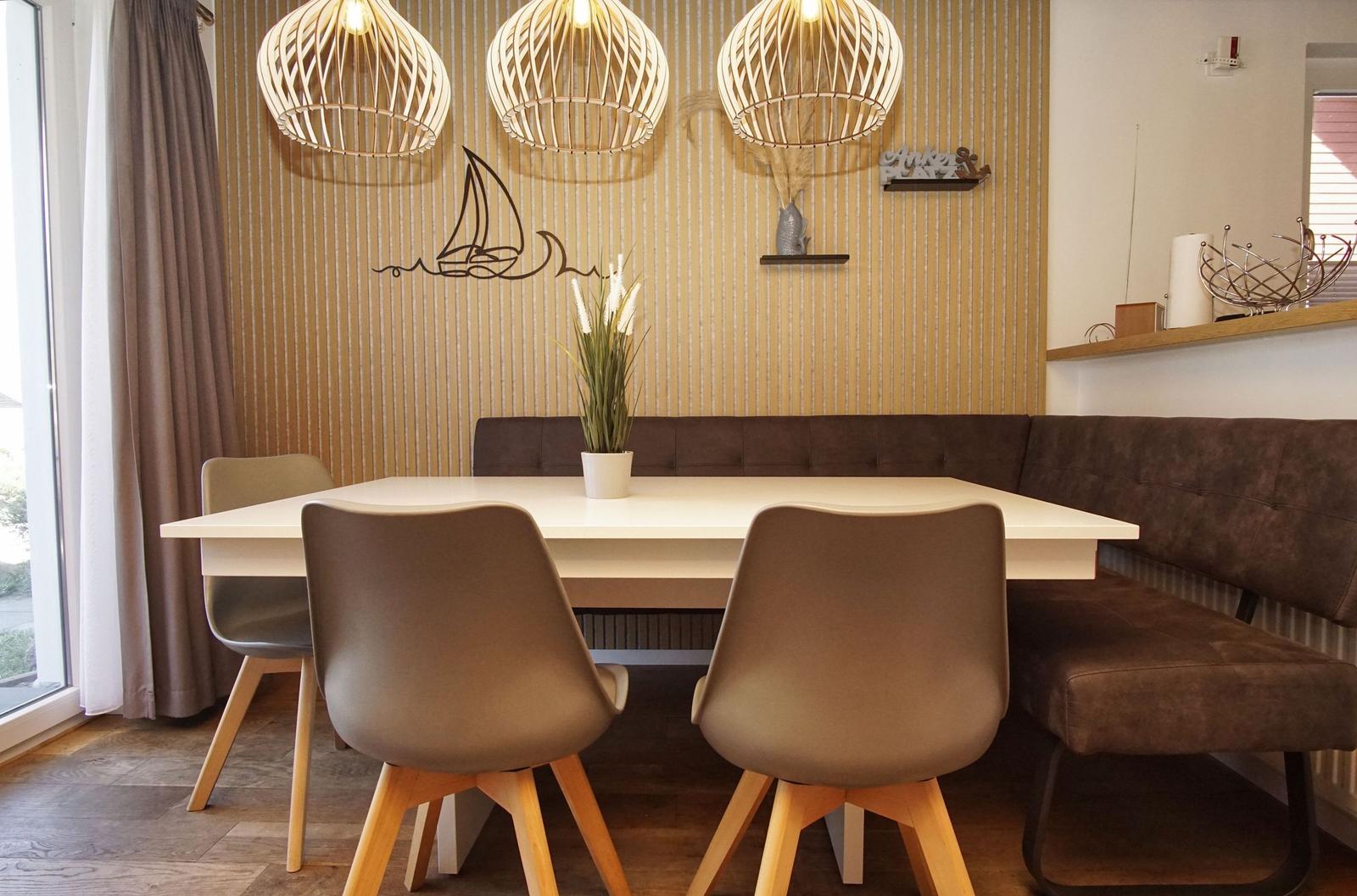 Dining area with table, chairs, and bench along the wall.