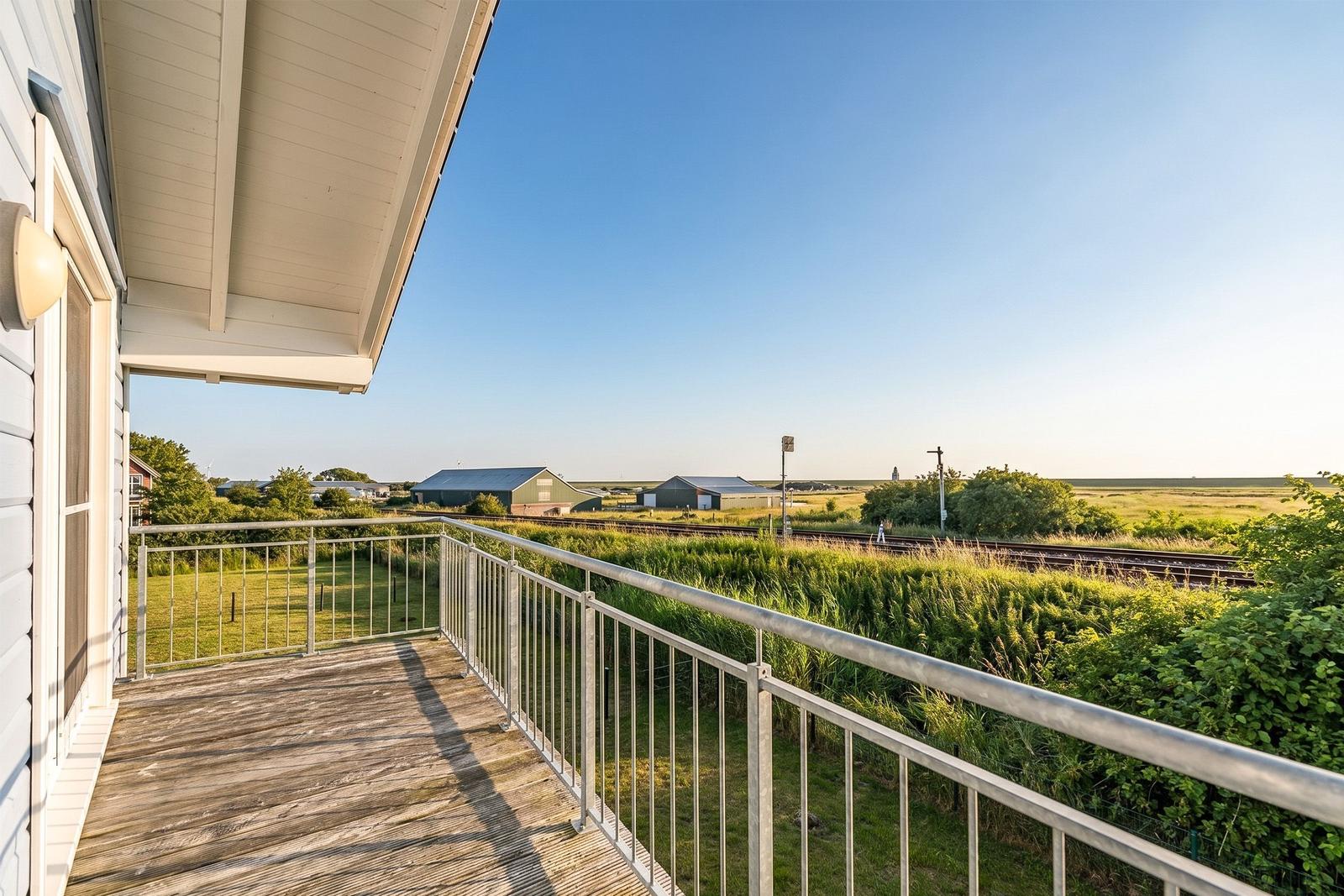 Terrasse mit Blick auf Bahngleis und grüne Landschaft