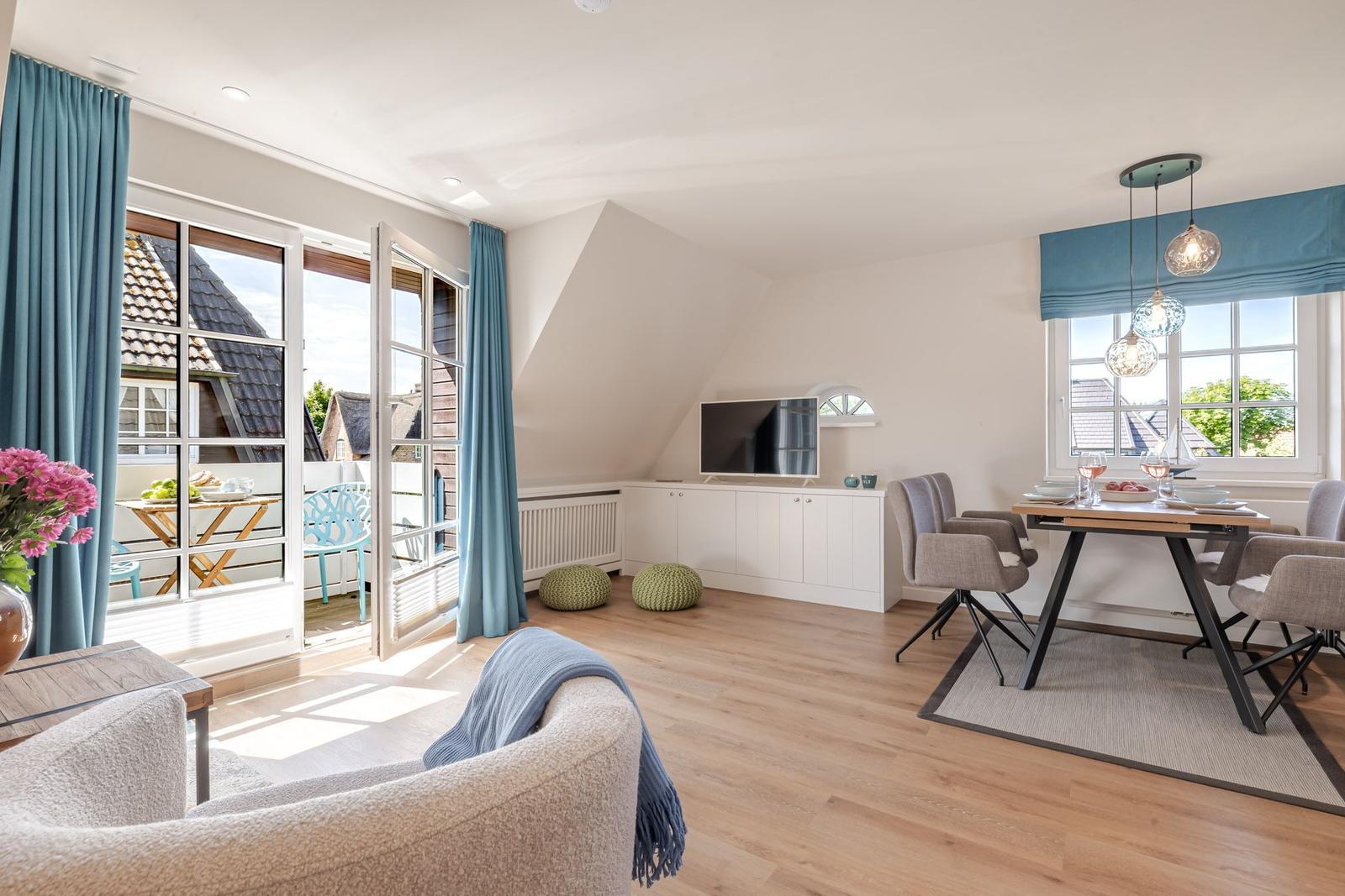 Living and dining area with balcony, TV, and wooden floor.