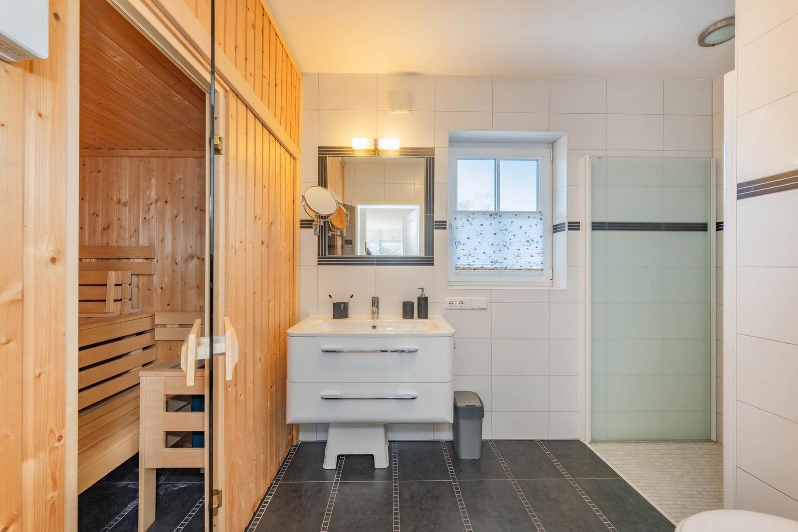 Bad mit Sauna, Dusche und Waschbecken