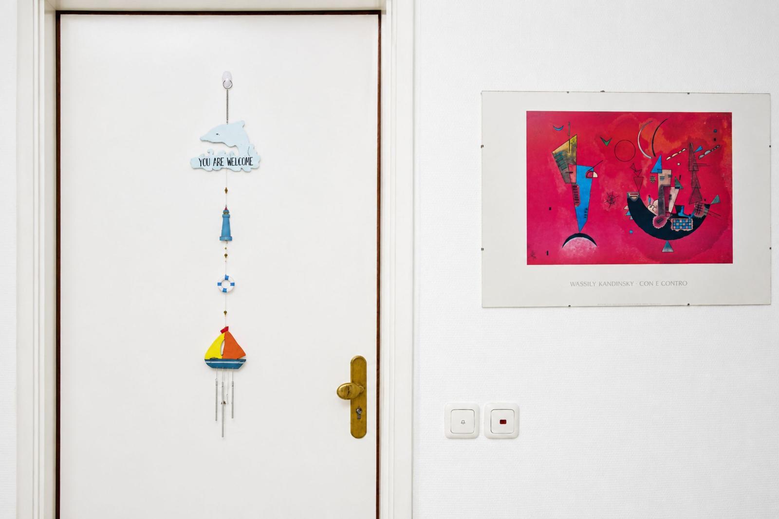 Door with wind chime and wall art by Wassily Kandinsky