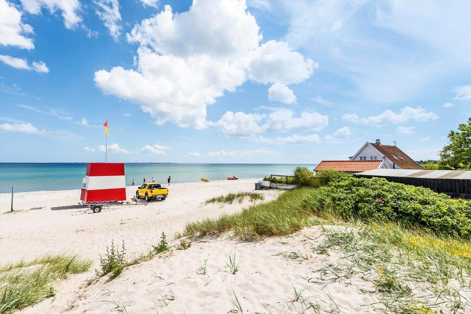 Beach house with sea view, sand dunes, and red roof